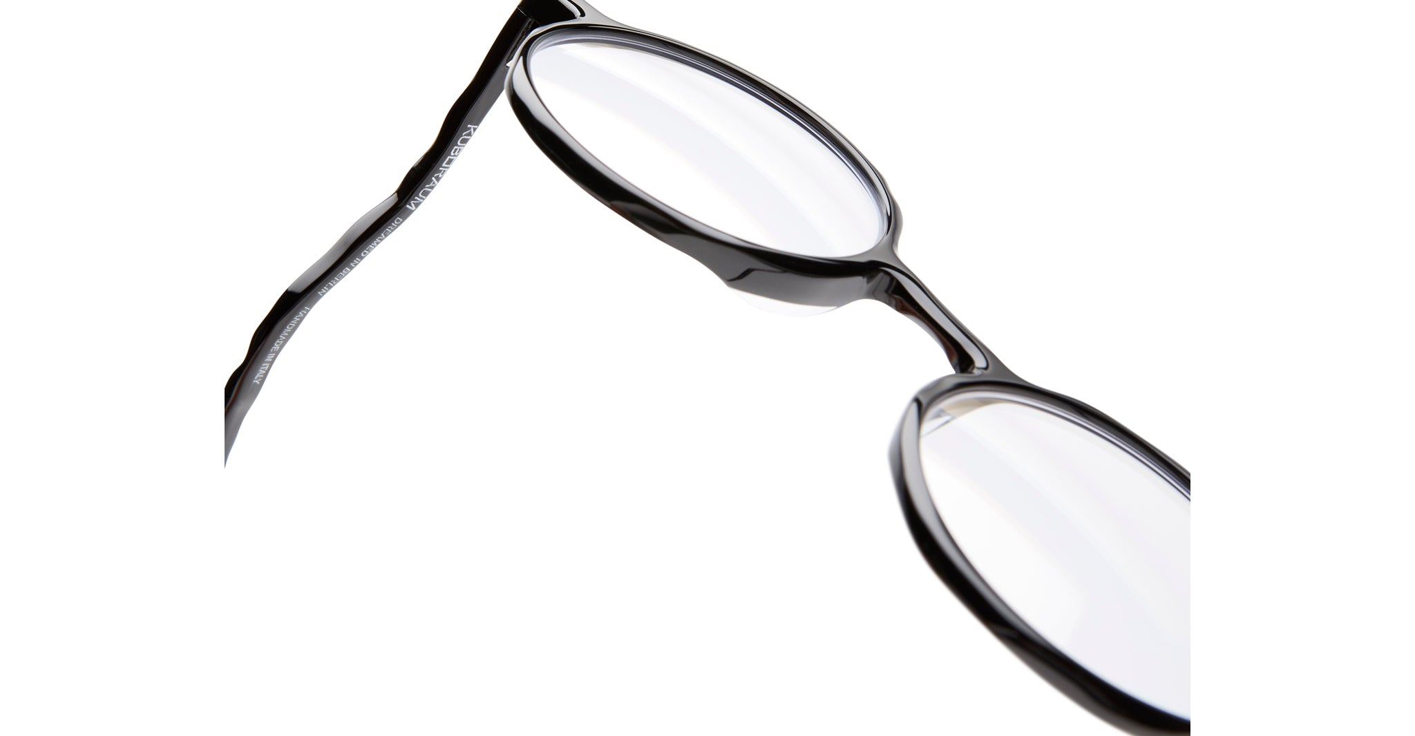 Close-up of KUBORAUM L11 eyeglasses, black-rimmed, clear lenses, frontal view, designer prescription eyewear.