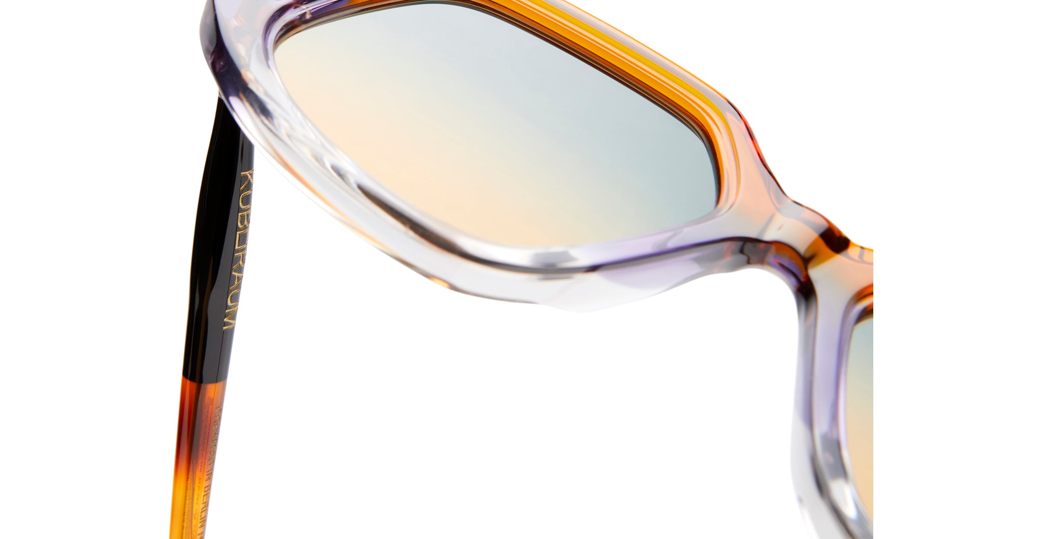 Close-up of Kuboraum P20 translucent eyeglasses frames with tinted lenses and KUBORAUM logo visible on the temple.