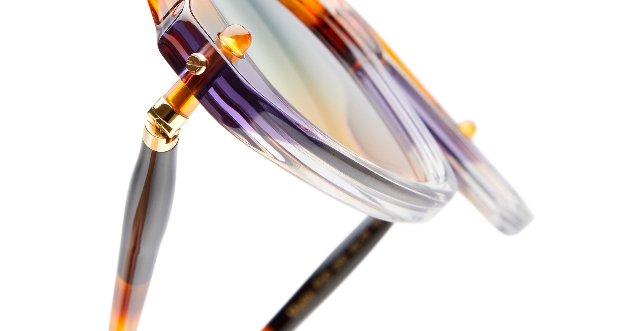 Close-up of Kuboraum P20 sunglasses by KUBORAUM, featuring tortoiseshell and clear frames, gold accents, and gradient lenses.