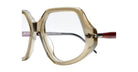 Close-up of Kuboraum P20 oversized eyeglass frames featuring geometric design, transparent beige rims, and red temples against a white background.