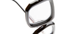 Close-up of Kuboraum P23 black, square-framed eyeglasses against a white background, highlighting the edges of the frames and the clear lenses.
