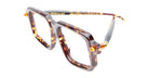 Kuboraum P23 oversized square eyeglasses, featuring a tortoiseshell pattern, transparent lenses, and gold hinge accents, displayed on a white background.