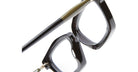 Close-up of the Kuboraum P25 eyeglasses’ black frames and temples against a white background, highlighting the angular lens design and glossy finish.