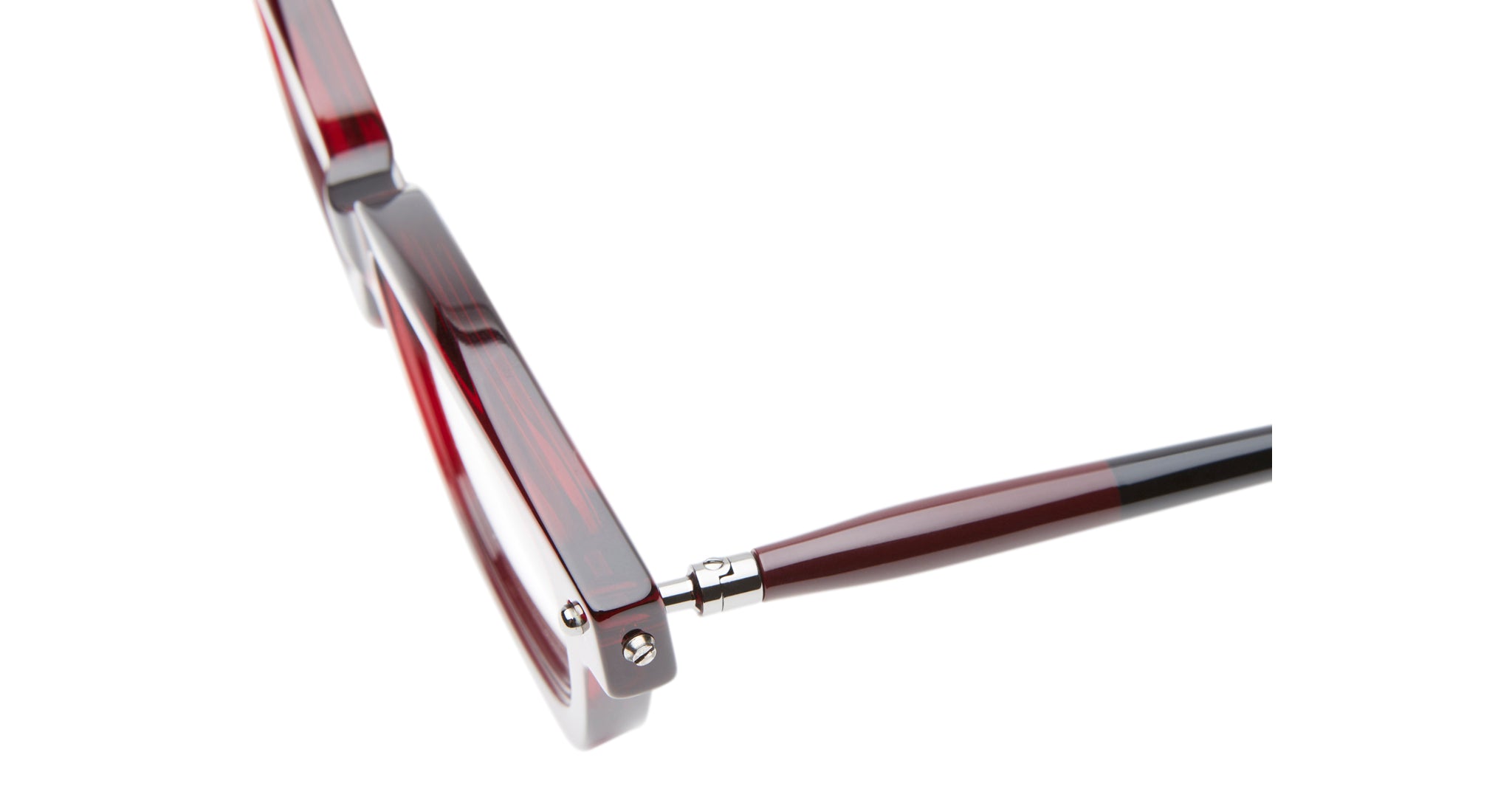 Close-up of the hinge and arm of Kuboraum P25 red and black eyeglasses, highlighting the connection between the rectangular frame and tapered arm against a white background.