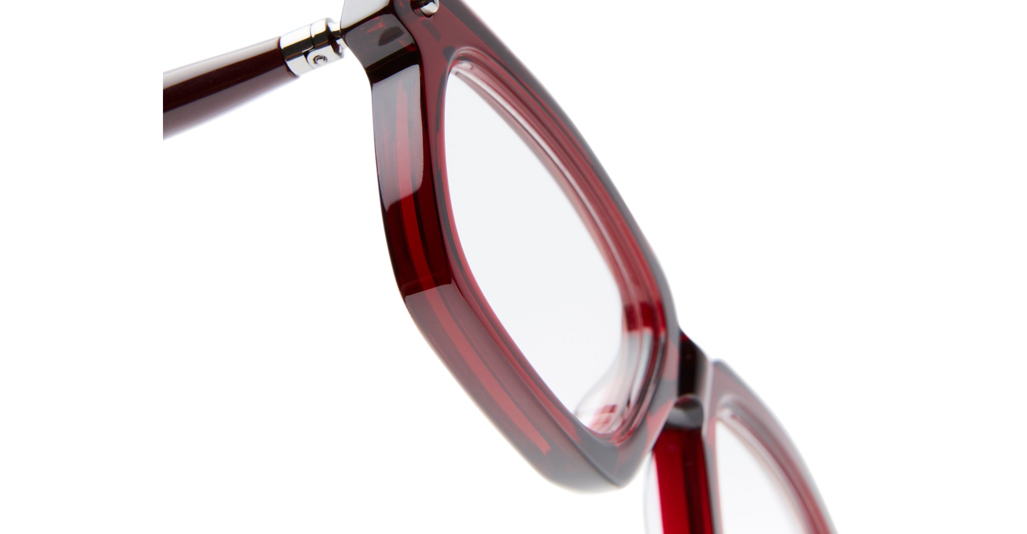 Close-up of the side and front of Kuboraum P25 eyeglasses, featuring thick translucent red frames, set against a white background.