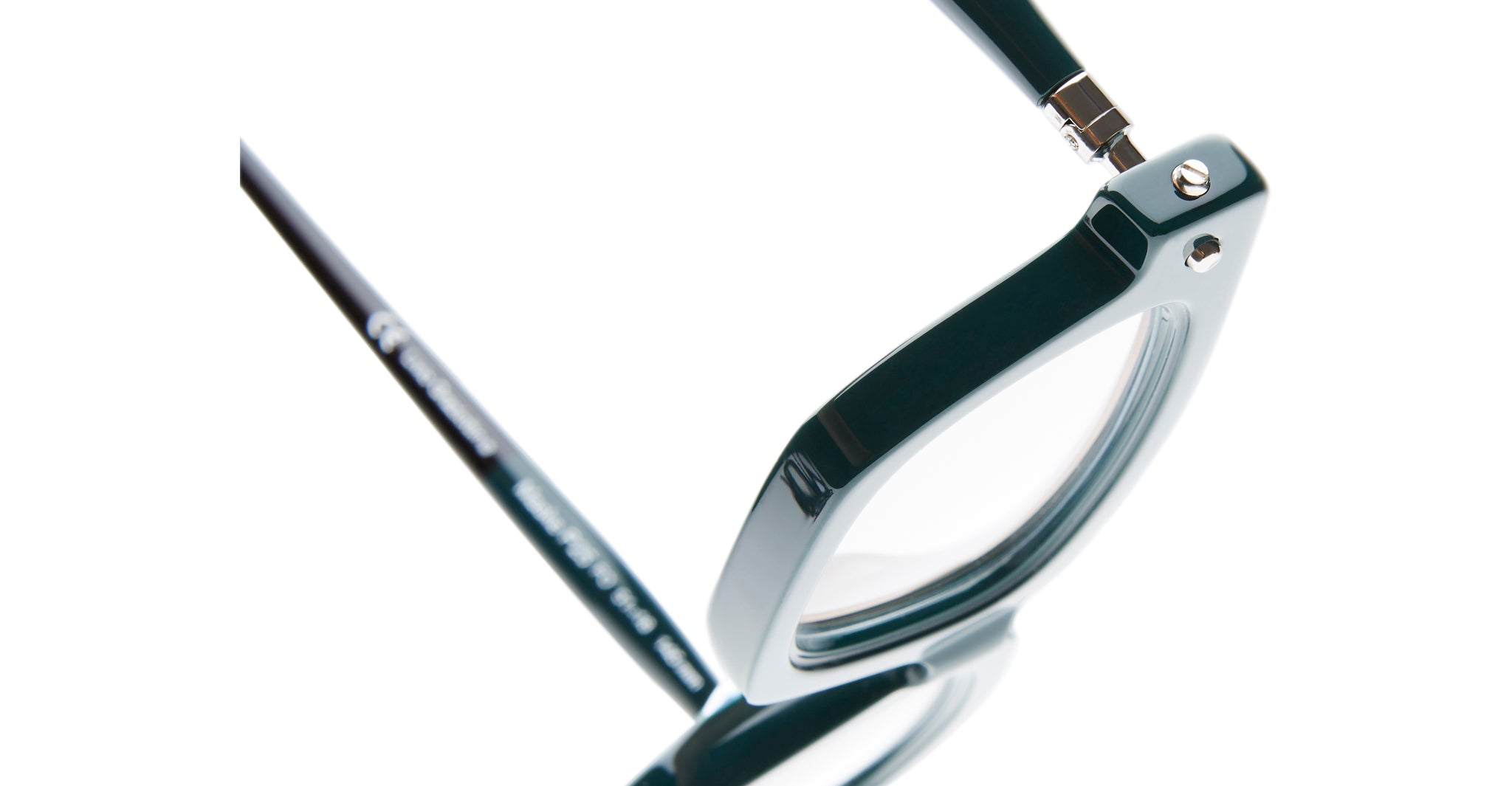 A close-up of the Kuboraum P25 dark-framed eyeglasses showcases the hinge and part of the lens set against a white background.
