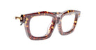 Close-up of Kuboraum P25 eyeglasses featuring thick brown tortoiseshell frames, gold hinge accents, and clear lenses, set against a white background.