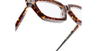 Close-up of Kuboraum P25 tortoiseshell eyeglasses featuring rectangular lenses and gold hinge details, set against a white background.