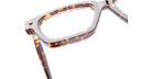 Close-up of the top half of Kuboraum P25 brown tortoiseshell eyeglasses with clear lenses, viewed at an angle against a white background.