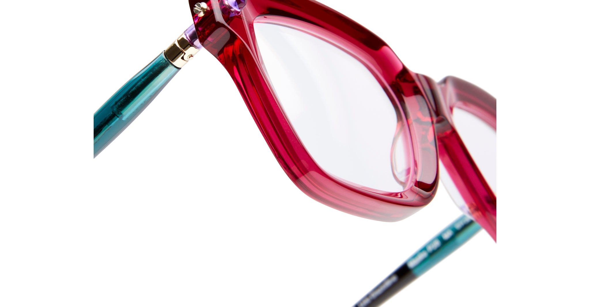 Close-up of Kuboraum P28 eyeglasses by KUBORAUM, showing translucent pink frames and teal arms from a front angle.