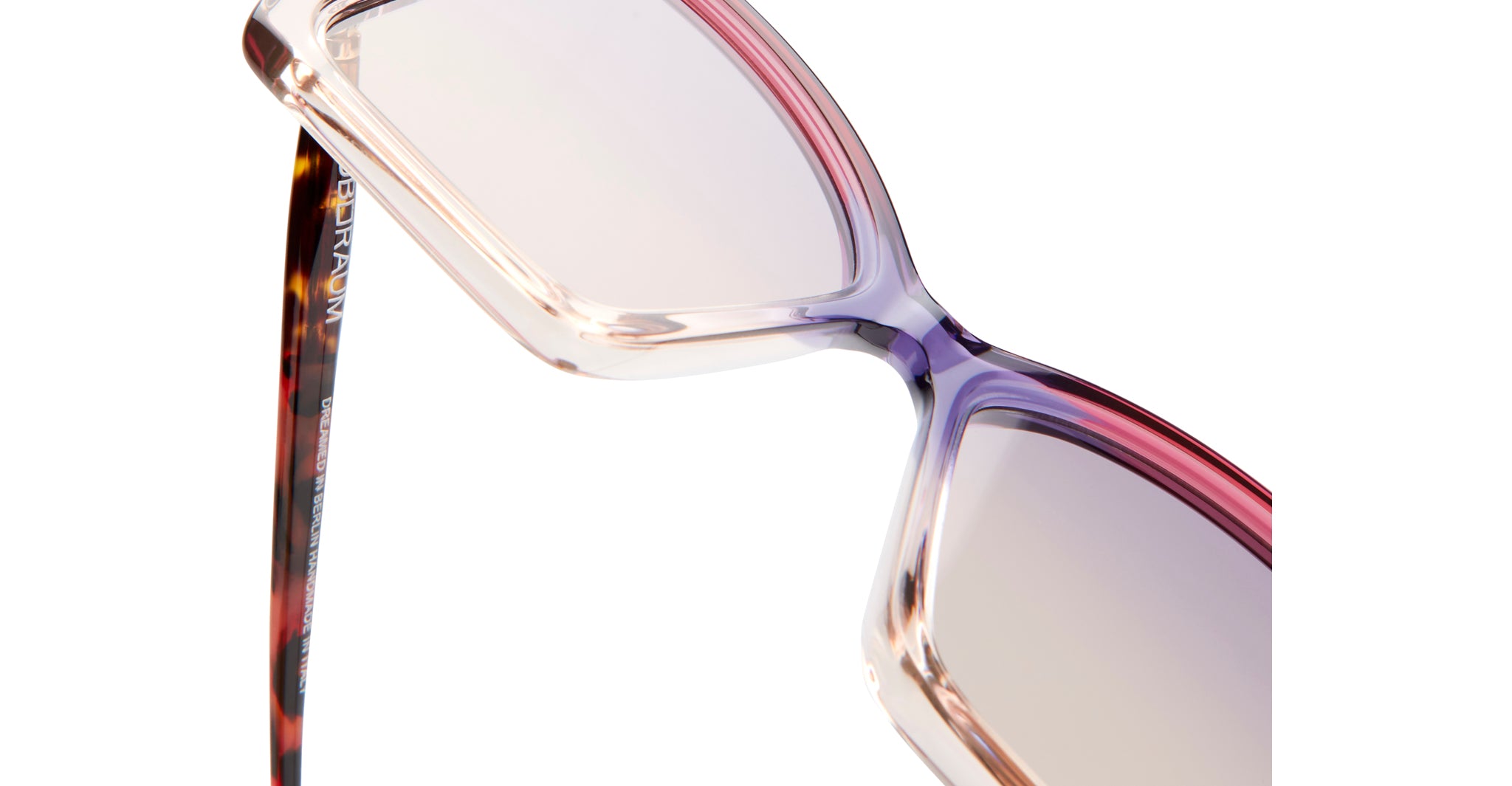 Close-up of KUBORAUM P30 eyeglasses, showing gradient pink-purple rectangular frames and tortoiseshell-patterned arms.