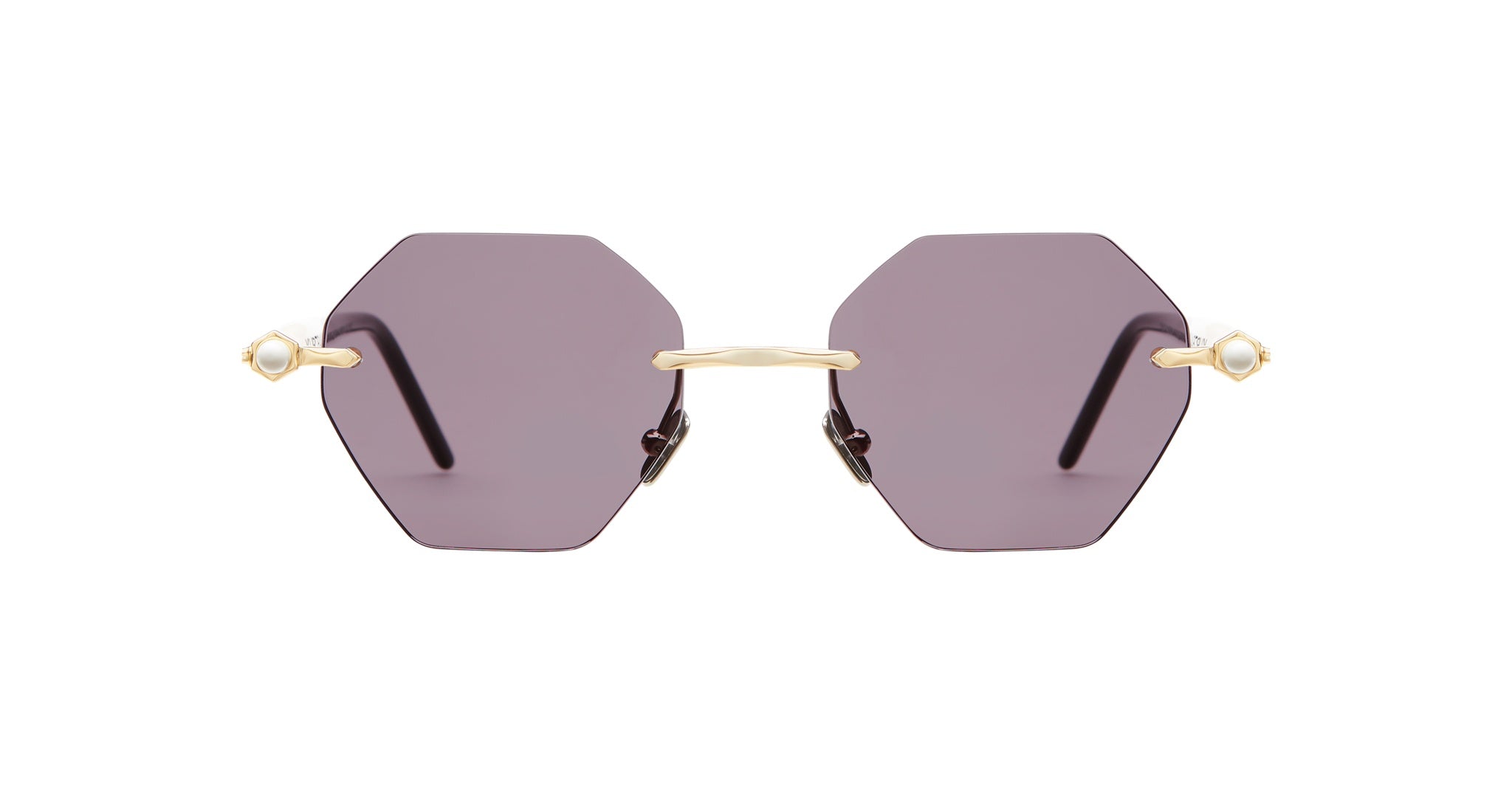 The Kuboraum P54 sunglasses feature hexagonal purple-tinted lenses, thin gold frames, and pearl-like embellishments at the outer corners, shown from the front.