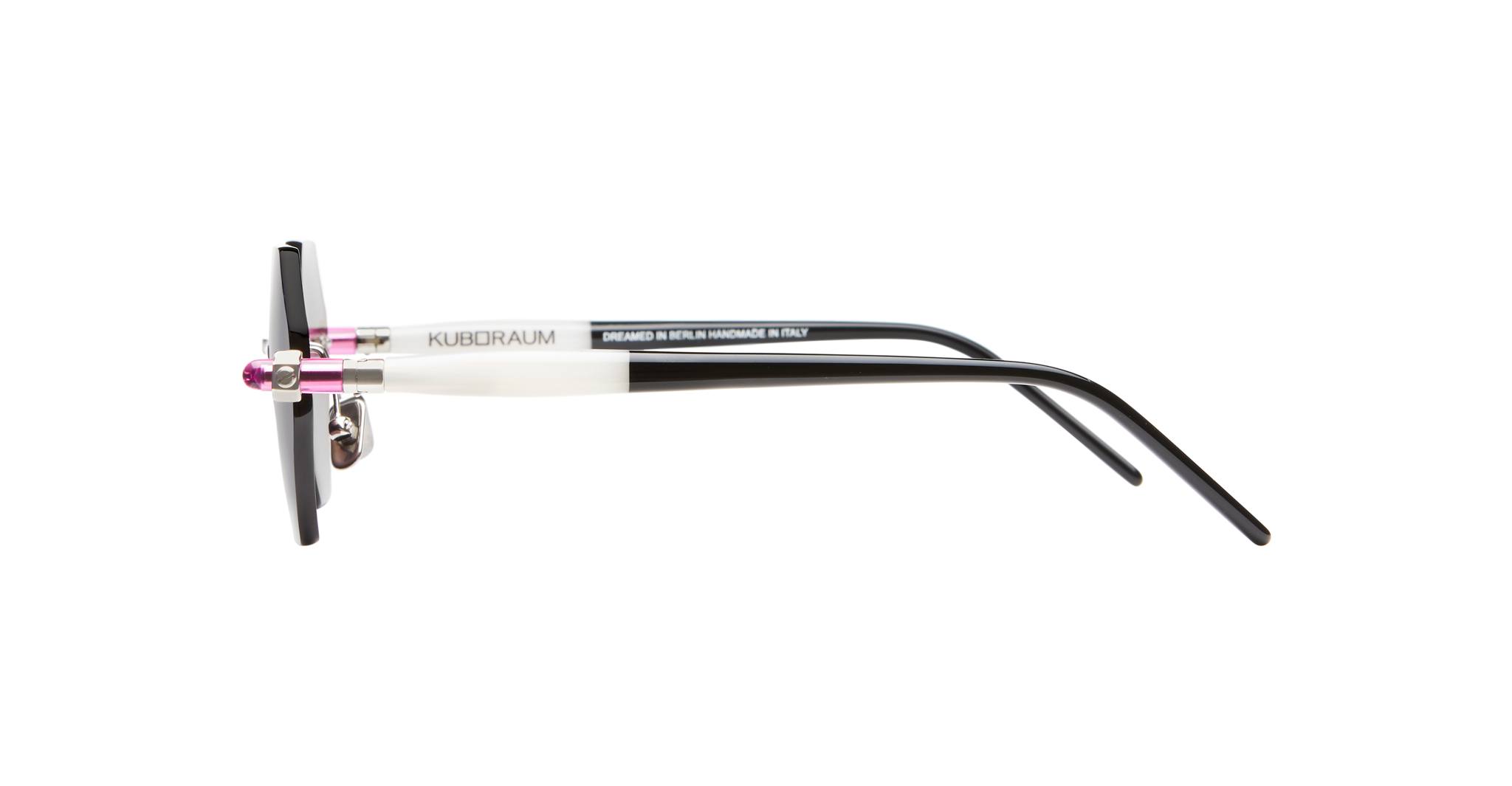 Side view of Kuboraum P54 eyeglasses in black and white with rectangular frames, thin arms, and pink accents near the hinges, displayed on a white background.
