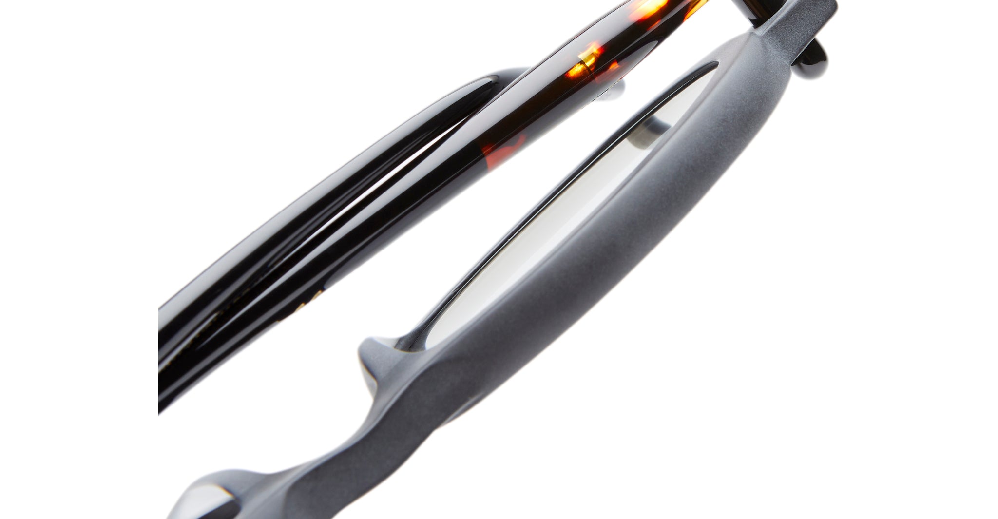 Close-up of the arms and frame of Kuboraum P6 eyeglasses, featuring black and tortoiseshell colors with clear lenses.