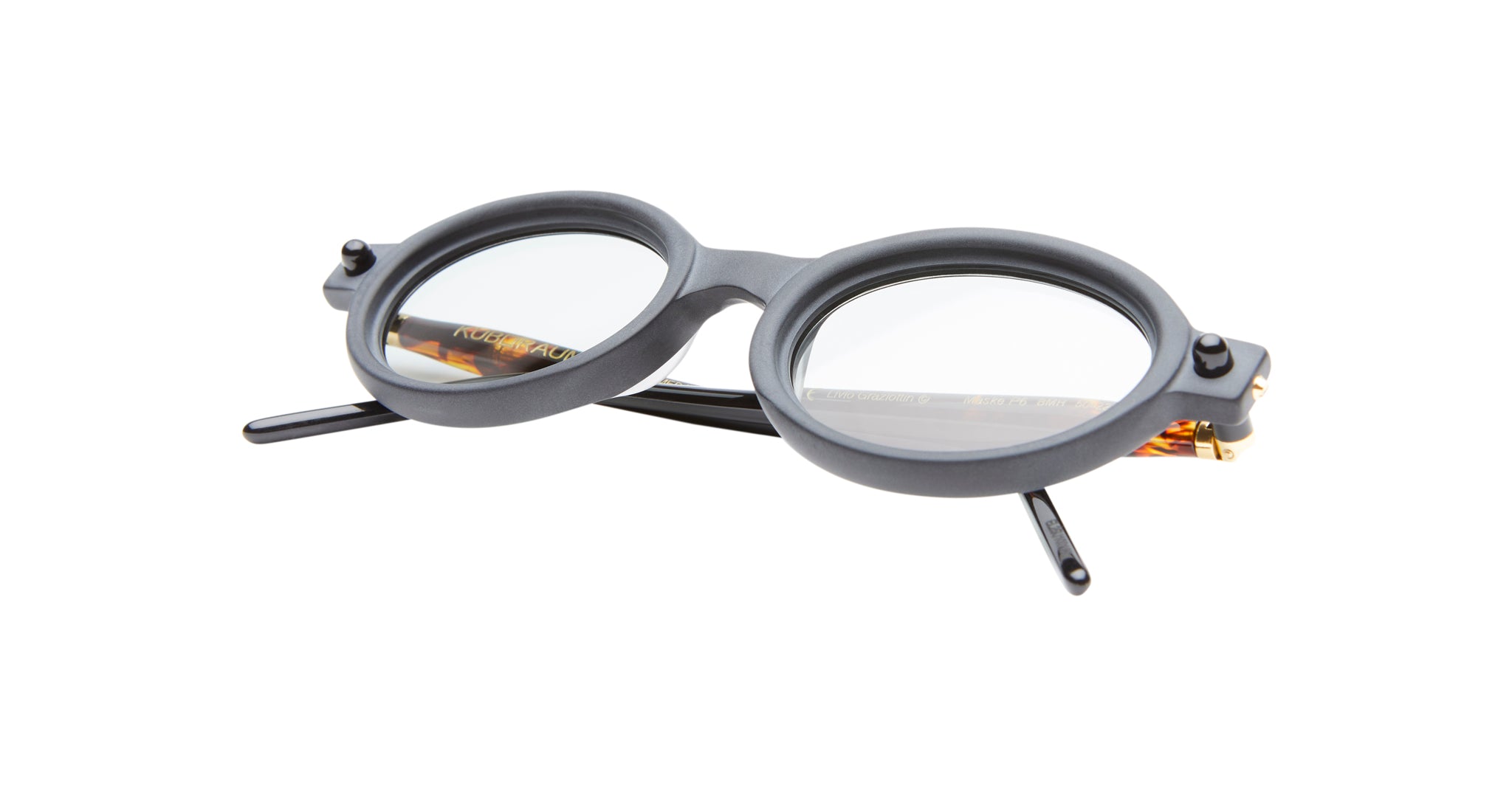 The Kuboraum P6 features round, black frames with clear lenses, displayed on a white background with the temples partially open.