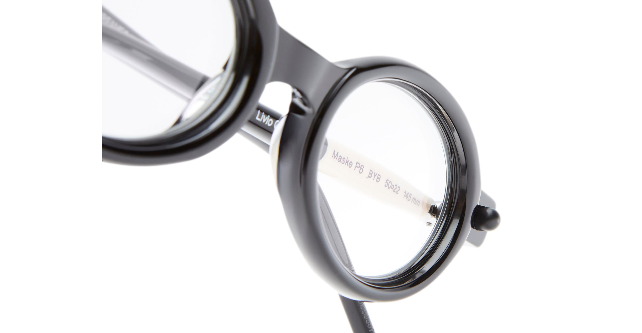 Close-up view of the Kuboraum P6 round black eyeglass frames with clear lenses, showcasing the bridge and part of the temple arm against a white background.