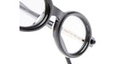 Close-up view of the Kuboraum P6 round black eyeglass frames with clear lenses, showcasing the bridge and part of the temple arm against a white background.