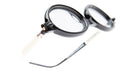 Close-up of Kuboraum P6 eyeglasses featuring round black frames and white temples, displayed at an angle on a white background.