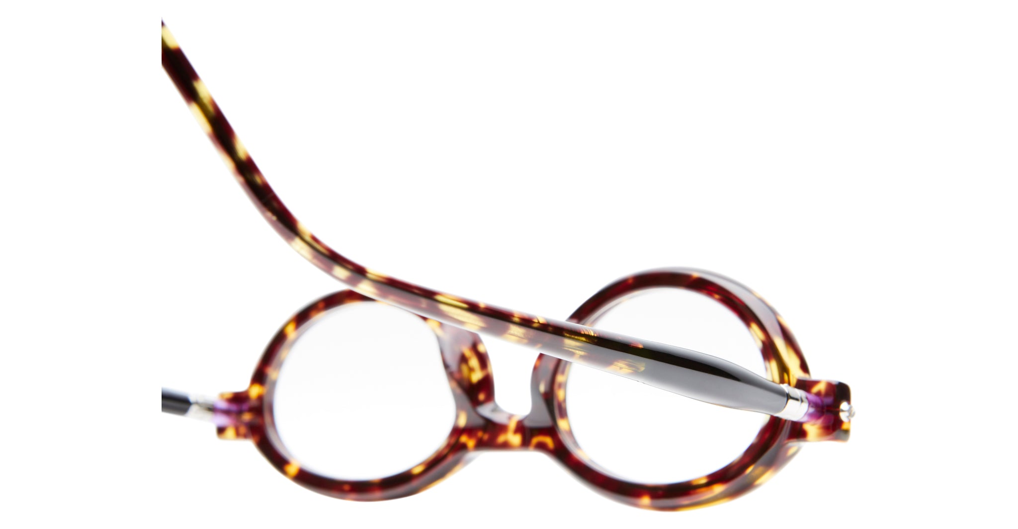 Kuboraum P6 round tortoiseshell eyeglasses with thick frames, shown from above at an angle with one temple arm raised, set against a white background.