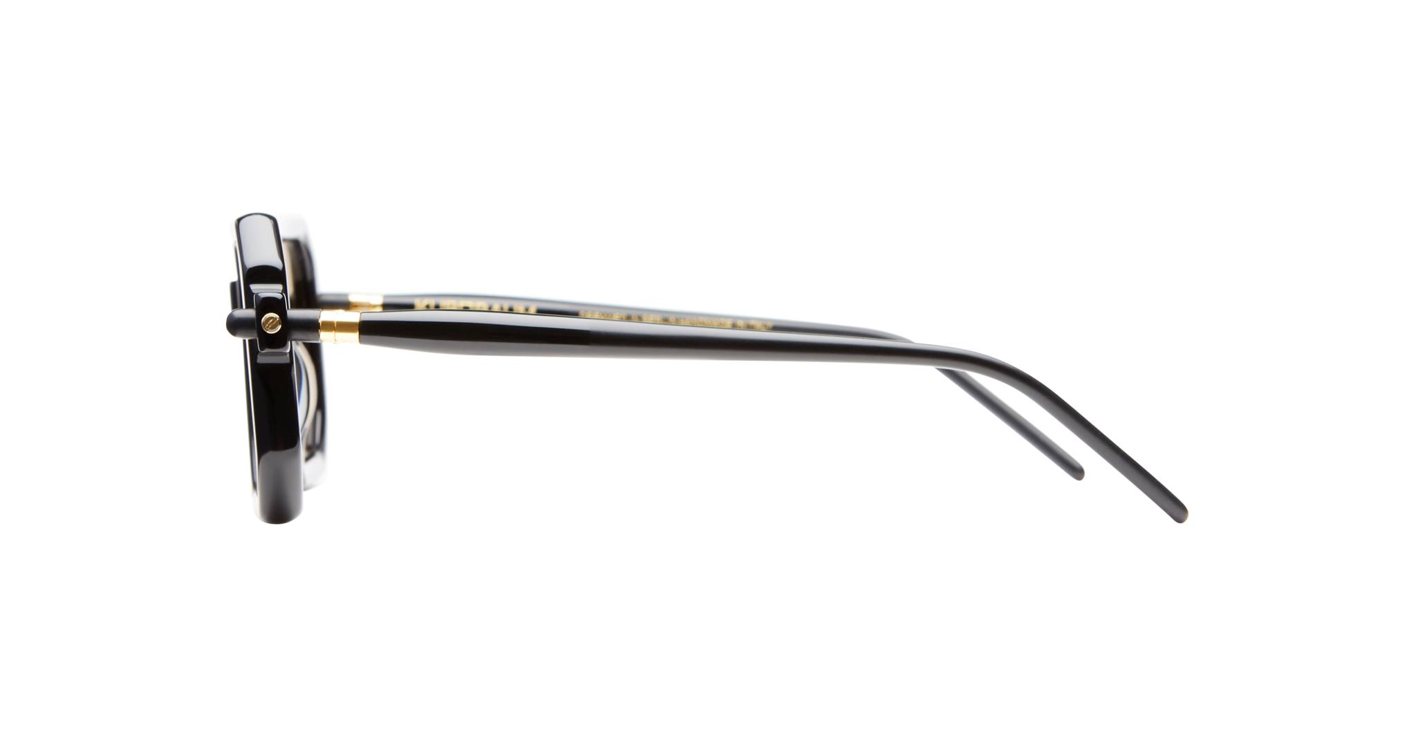 Side view of Kuboraum P8 eyeglasses by KUBORAUM with black frames, gold accents, and straight temple arms.