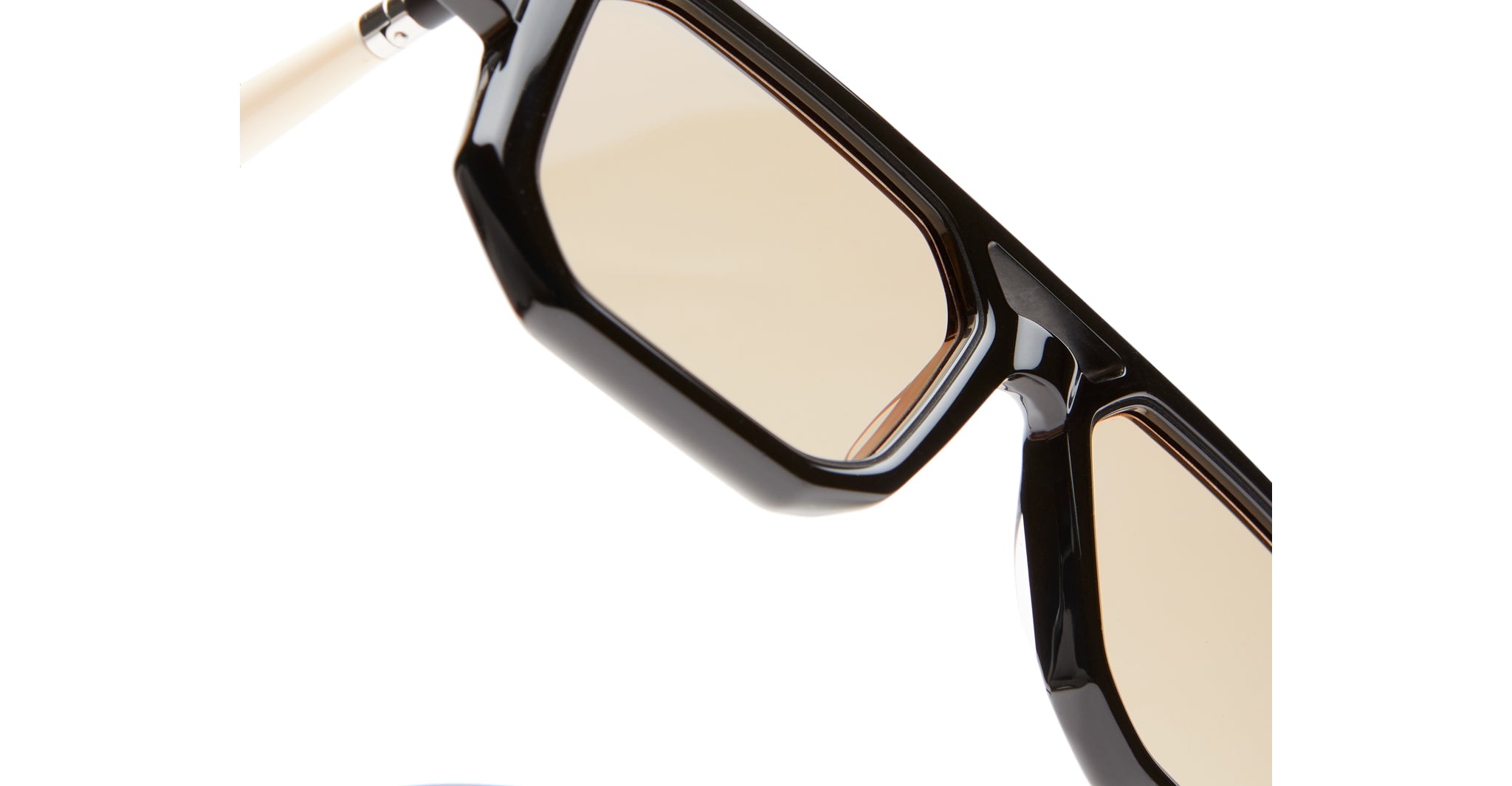 Kuboraum P8 black rectangular eyeglasses with beige lenses, close-up view showing frame details.