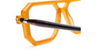 Close-up of Kuboraum P8 orange geometric eyeglass frames with black and brown acetate temple arms, viewed from the front.