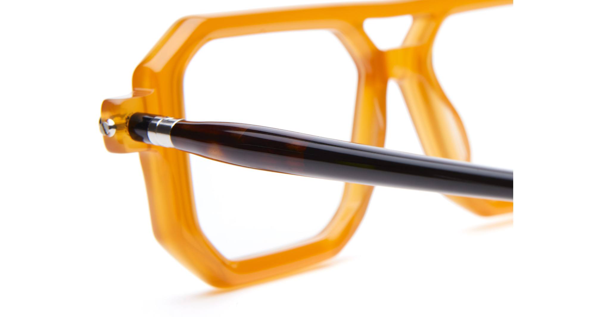 Close-up of Kuboraum P8 orange geometric eyeglass frames with black and brown acetate temple arms, viewed from the front.