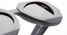 Close-up of the Kuboraum X22 sunglasses featuring thick, matte gray frames and dark lenses. The image highlights the textured, angular design of the frames set against a white background.