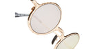 Close-up of Kuboraum Z17 round sunglasses with gold frames and tinted lenses, shown on a white background.