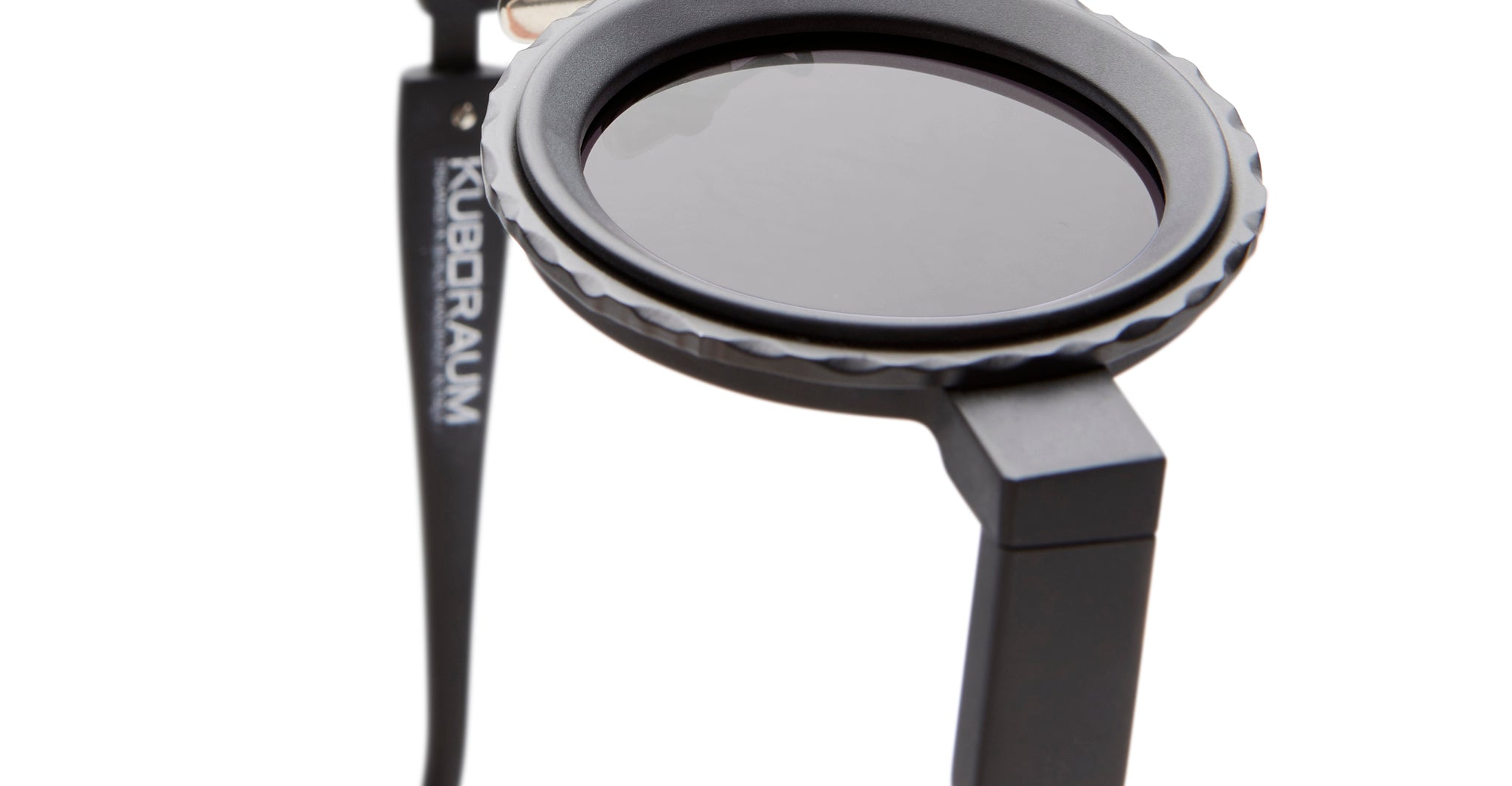 Close-up of KUBORAUM Z3 eyeglasses showing a thick, angular black frame with round lenses, front view.