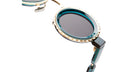 Close-up of Kuboraum Z3 round sunglasses with teal frames, gold details, and dark lenses, front angle visible.