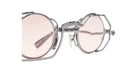 Close-up view of the Kuboraum Z50, featuring stylish round sunglasses with light pink lenses and a unique, intricate silver metal frame, shown against a white background.