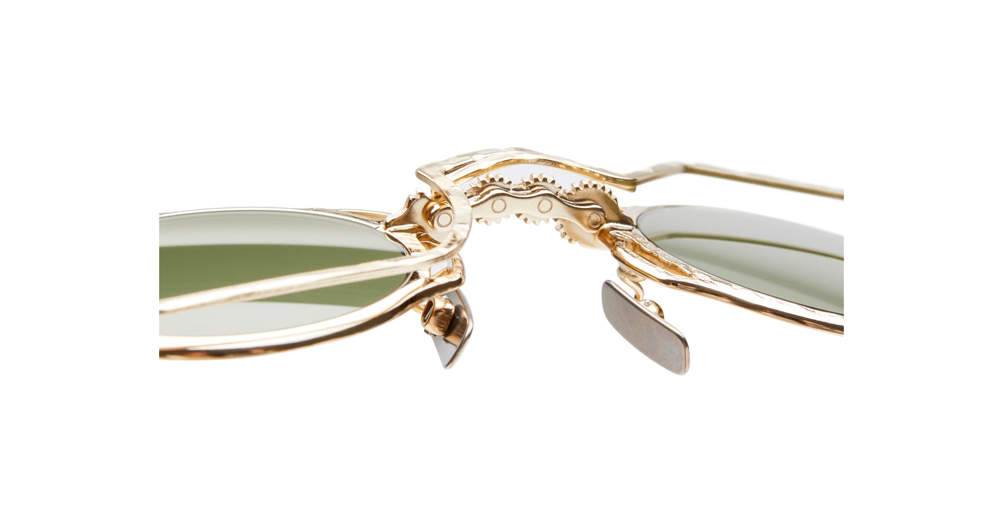 Close-up of KUBORAUM Z50 gold-frame sunglasses showing green lenses, detailed metalwork, and adjustable nose pads.