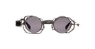 Kuboraum Z50 sunglasses by KUBORAUM, shown from the front, feature round geometric frames, gray lenses, and metal sides.