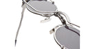 Close-up of Kuboraum Z50 round sunglasses with silver frames and mechanical-inspired hinges, front angle.