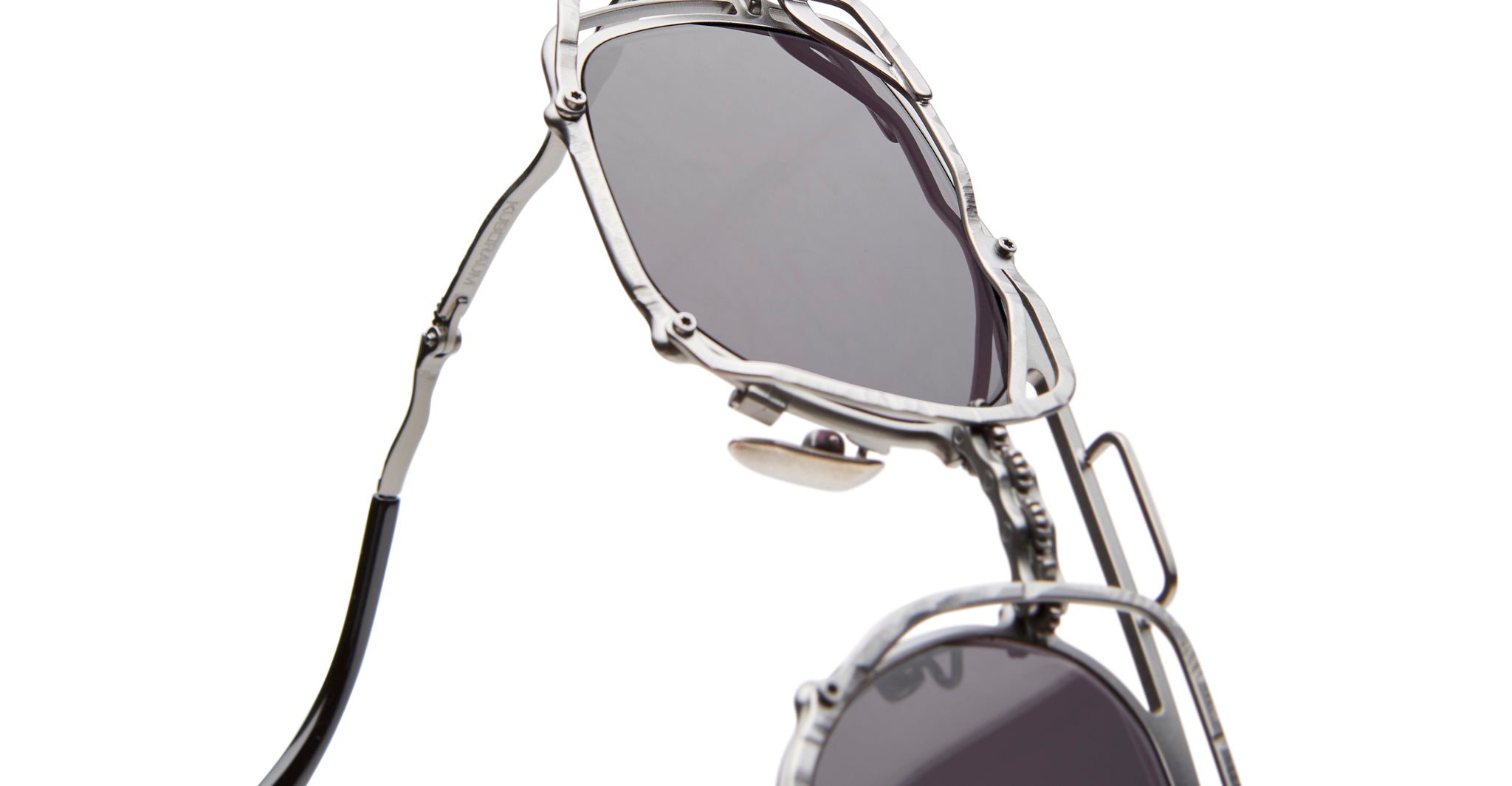 Close-up of KUBORAUM Z51 geometric metal sunglasses with dark lenses, front angle, showing brand and model details.