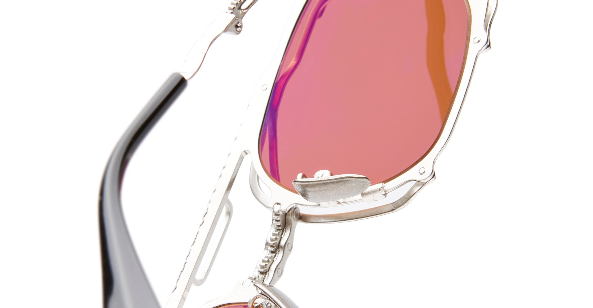 Close-up of KUBORAUM Kuboraum Z51 sunglasses featuring silver frames and pink-tinted lenses, viewed from the front.