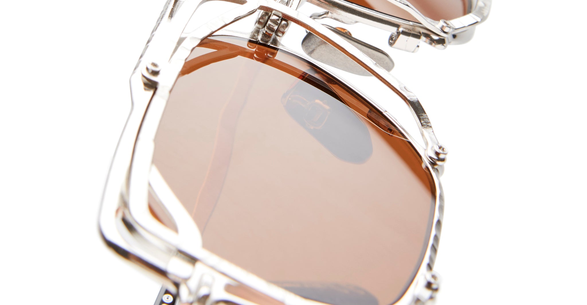 Close-up of KUBORAUM Z51 silver sunglasses with brown lenses, showing front view of the eyewear.