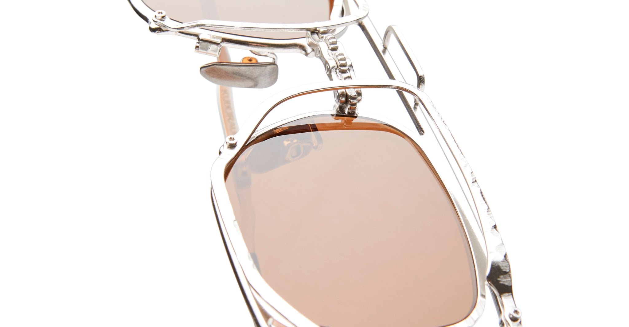 KUBORAUM Z51 sunglasses close-up showing silver frame and light brown lenses, front angle.