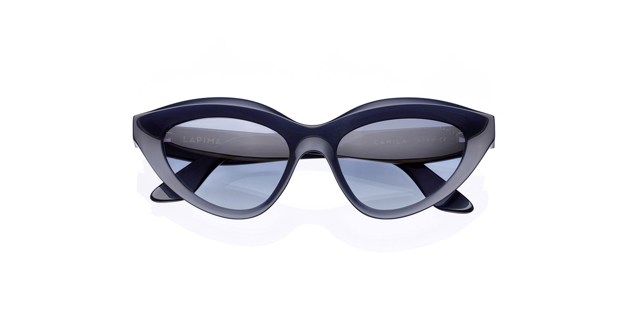 The Lapima Camila are dark blue cat-eye sunglasses crafted from premium Italian acetate with thick frames and UV-protected lenses, shown against a white background.