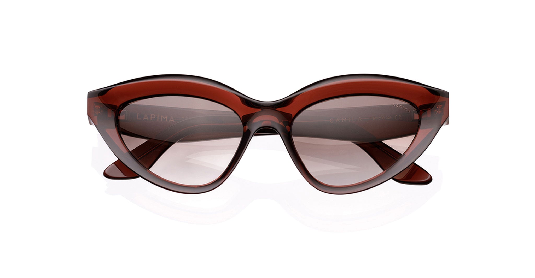 The Lapima Camila is a pair of brown cat-eye sunglasses made from Italian acetate, featuring thick glossy frames and UV-protected lenses, displayed against a white background.