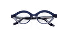 The Lapima Isa eyeglasses by COMING SOON feature thick, round, dark blue frames with clear lenses, displayed front-facing on a white background.
