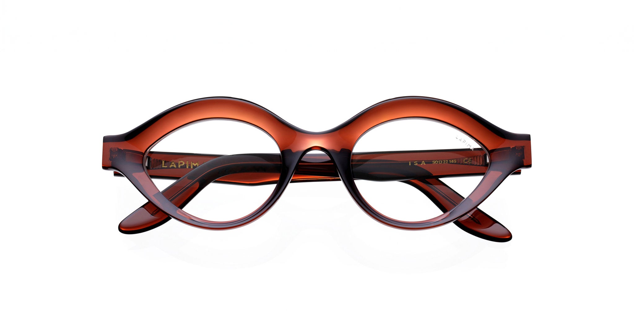 The Lapima Isa by COMING SOON features round, dark brown thick frames with an upward-curved bridge. Displayed front-on against a white background, the eyeglasses have their temples crossed behind.