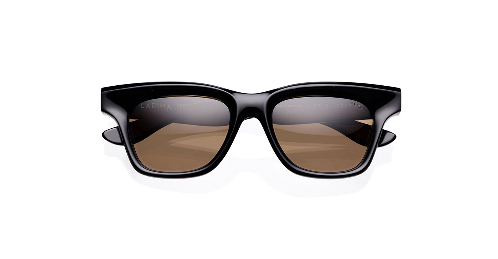 The Lapima Leo X features black rectangular sunglasses with thick handcrafted Italian acetate frames and brown-tinted lenses, shown against a white background. Part of our optical frames and sunglasses collection for versatile style.