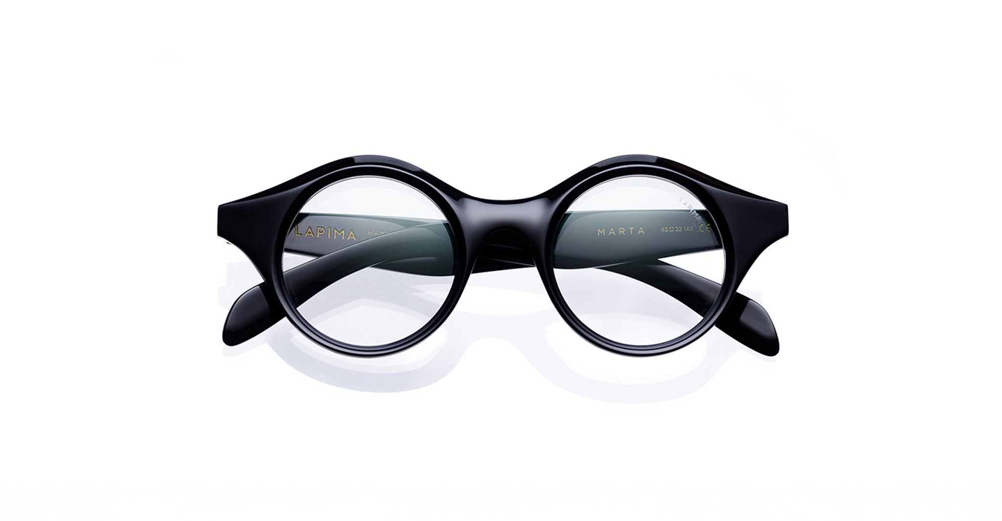 A pair of round, black Lapima Marta eyeglasses with thick Italian acetate frames, seen from the front on a white background. "LAPIMA" and "MARTA" appear inside the left temple.