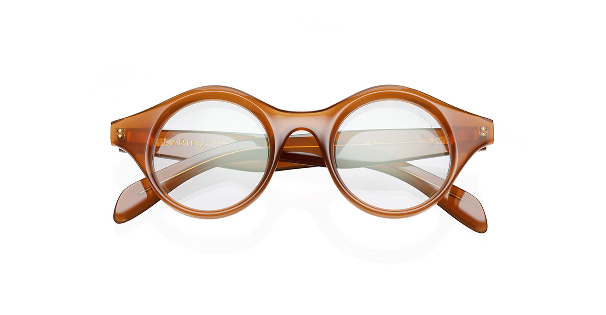 The Lapima Marta eyeglasses are round acetate frames handcrafted in Brazil, with clear lenses, a vintage-inspired bold design, keyhole bridge, and thick rims. Shown front view on a white background.