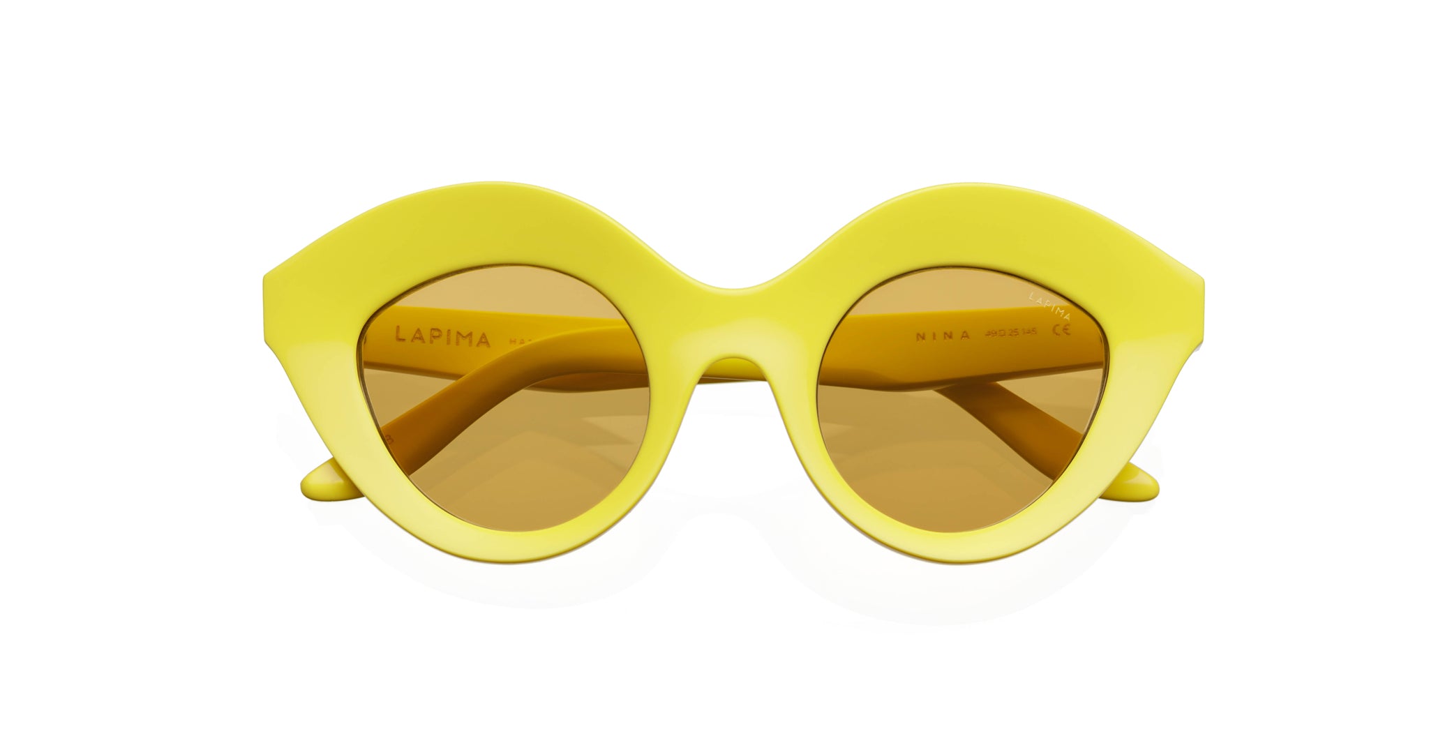The Lapima Nina sunglasses feature thick, glossy round yellow frames with brown-tinted lenses and the Lapima brand name on the left inner arm.