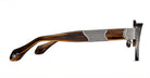 Side view of Matsuda 10605H brown tortoiseshell eyeglass frames featuring silver metal ribbed arm accents and a small white logo near the temple tip, set against a white background.