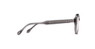Side view of Matsuda M1032 translucent gray eyeglasses with clear lenses, decorative metal inlay on the arms, and subtle skull emblems by the hinge and temple tip.
