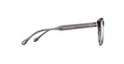 Side view of Matsuda M1036 (Copy) eyeglasses featuring transparent gray frames and decorative temple detailing, set against a white background.